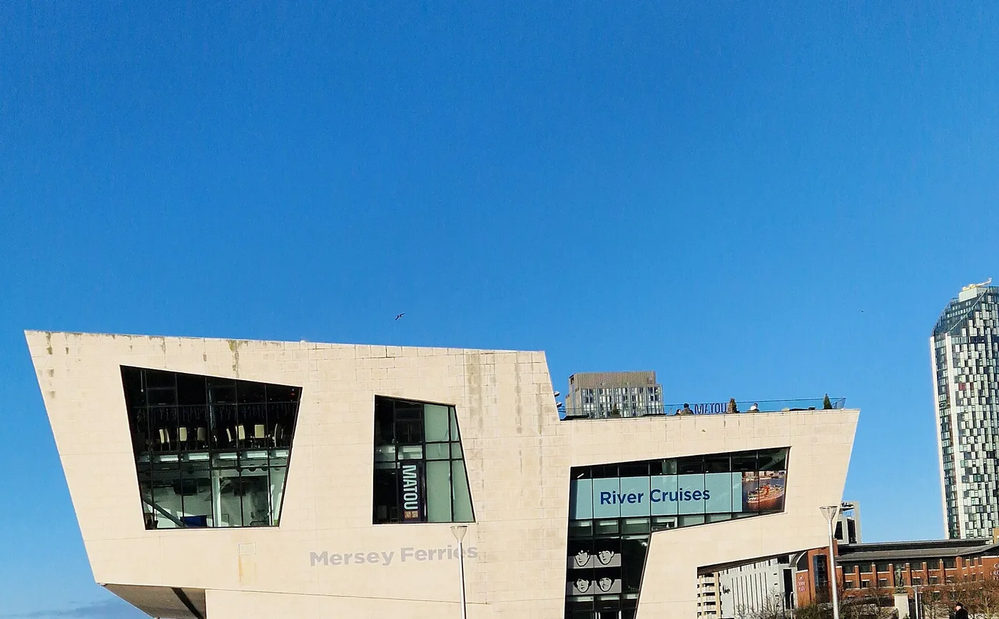 The white Mersey Ferries terminal building at Pier Head against a blue sky